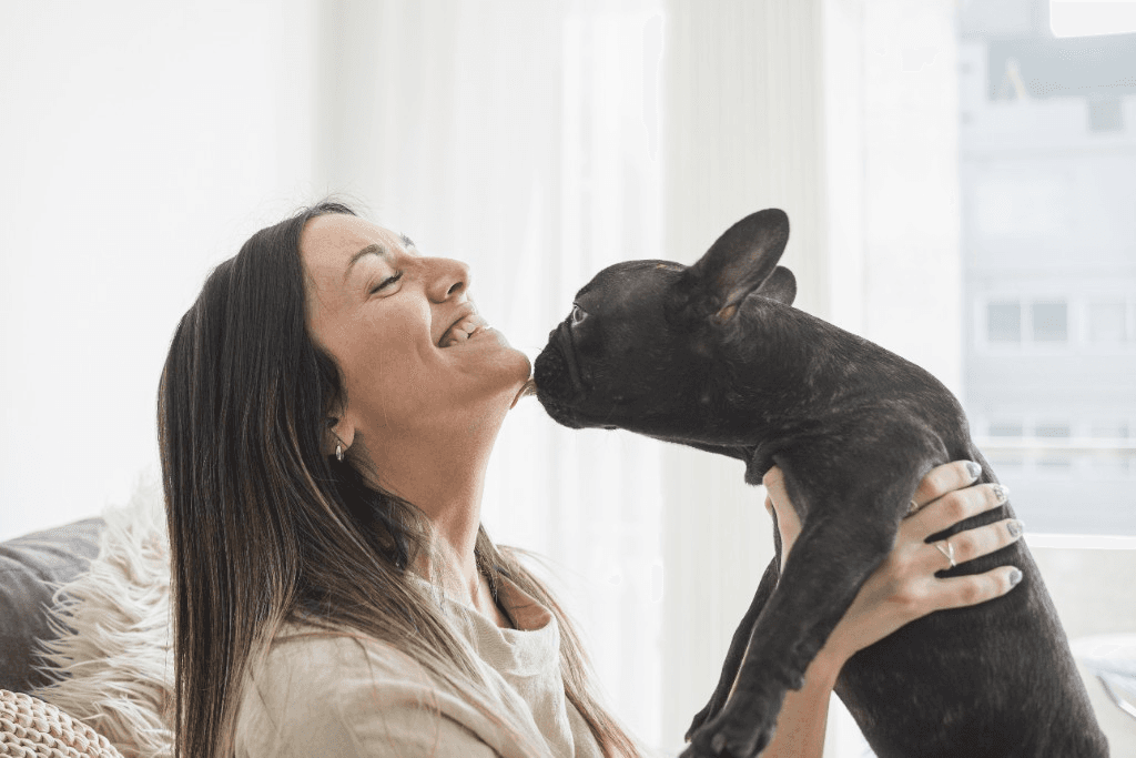 Pet parent sharing a loving moment with her dog